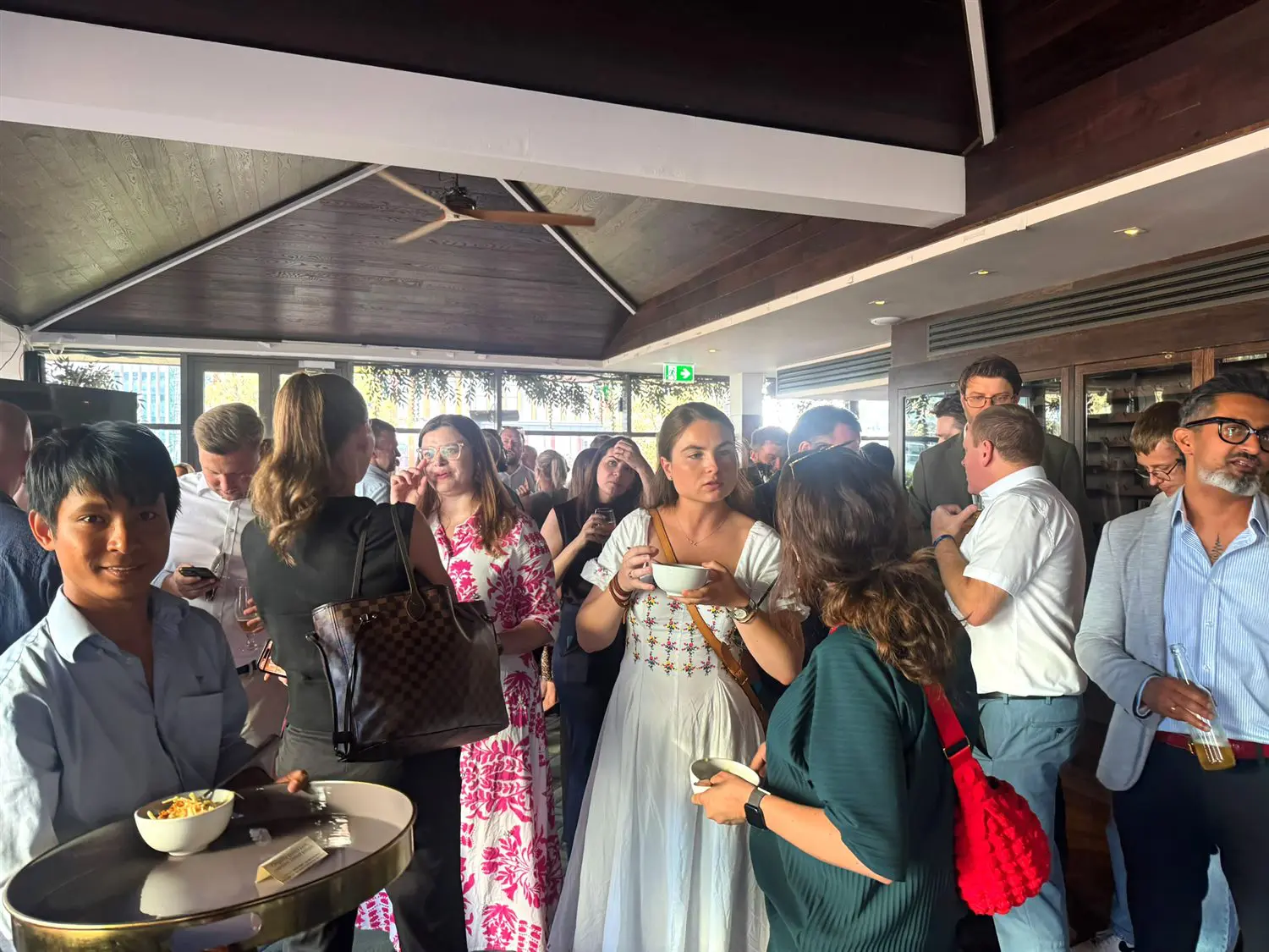 Guests mingling at the Summer Party drinks reception